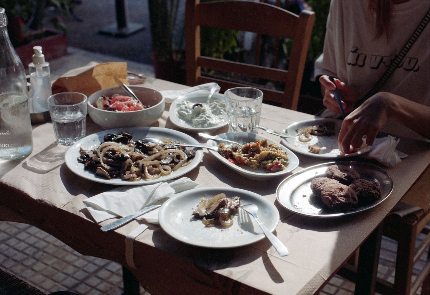 Shared plates on a sunny outdoor table